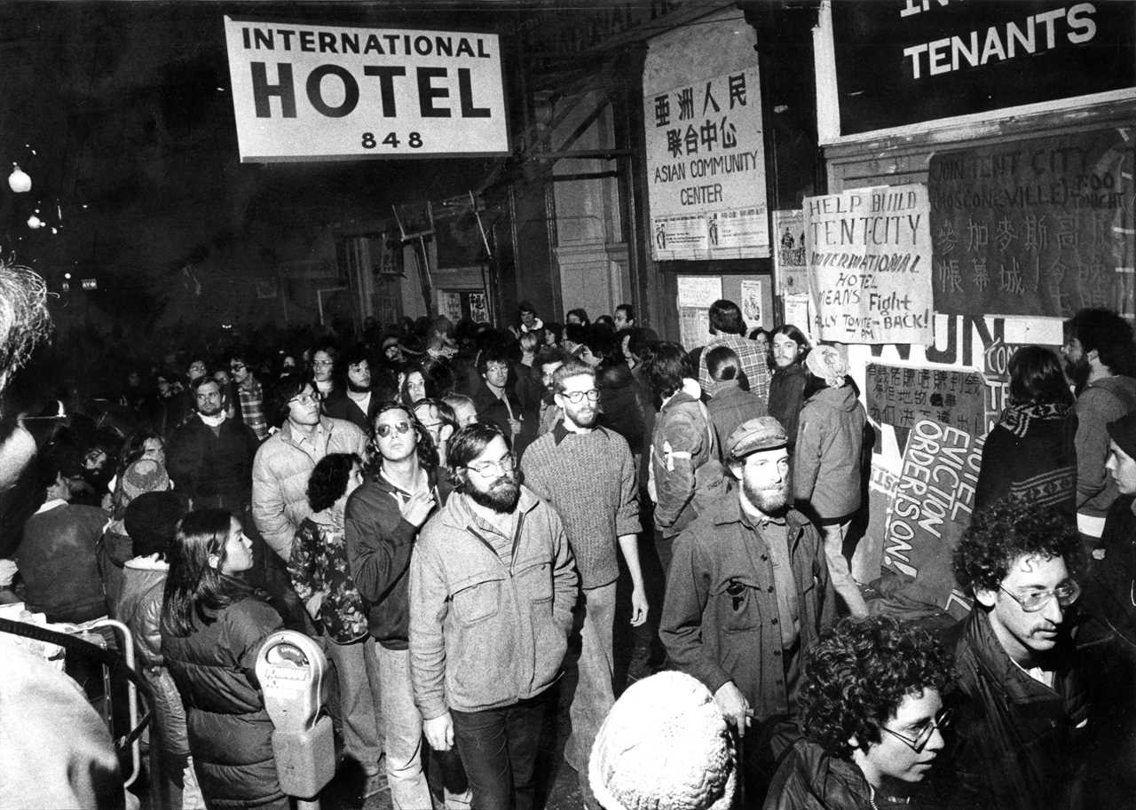 Crowds of people marching outside I-Hotel before evictions