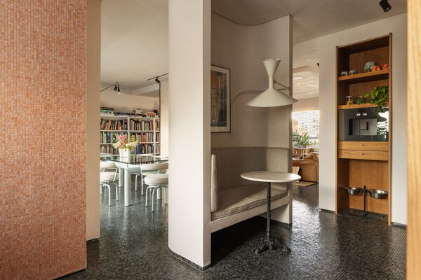 A cozy breakfast nook is nestled in the partition wall separating the kitchen and living room.