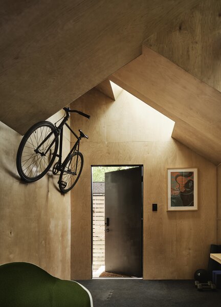 Despite its small footprint, the flexible, multi-purpose space includes bike storage and a niche for storing weights.