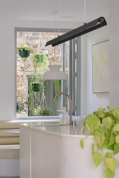 The internal courtyard acts as a light well and, thanks to the hanging plants, helps Chester and Chloe escape the busy city beyond. "The greenery feels like it's inside the house,