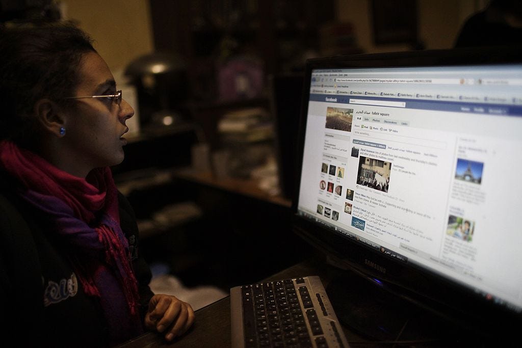 CAIRO, EGYPT - FEBRUARY 7, 2011: Egyptian youth Mariam Aboghazi, 20, updates a Facebook page with new information about the protesters in Tahrir Square in Cairo, Egypt on February 7, 2011. A group of Egyptian youth have been collecting testimonies and voices of the protesters in Tahrir Square, and publishing them on social networking sites like Facebook and Twitter.