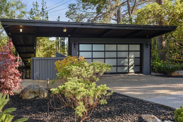 The sleek two-car garage is the only part of the property that is visible from the street.