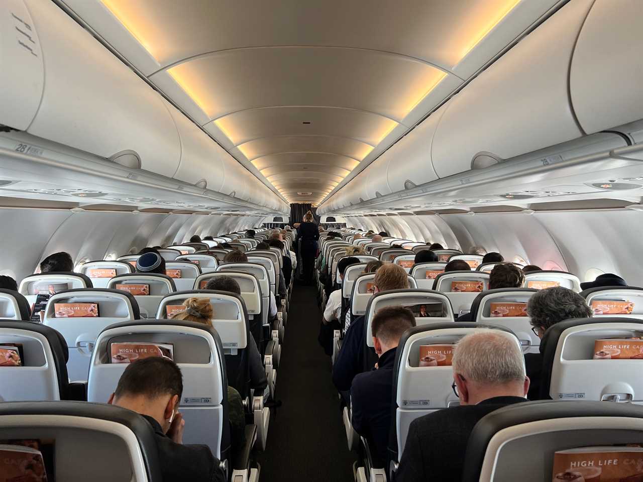 A view of the aisle of a British Airways Airbus A320.