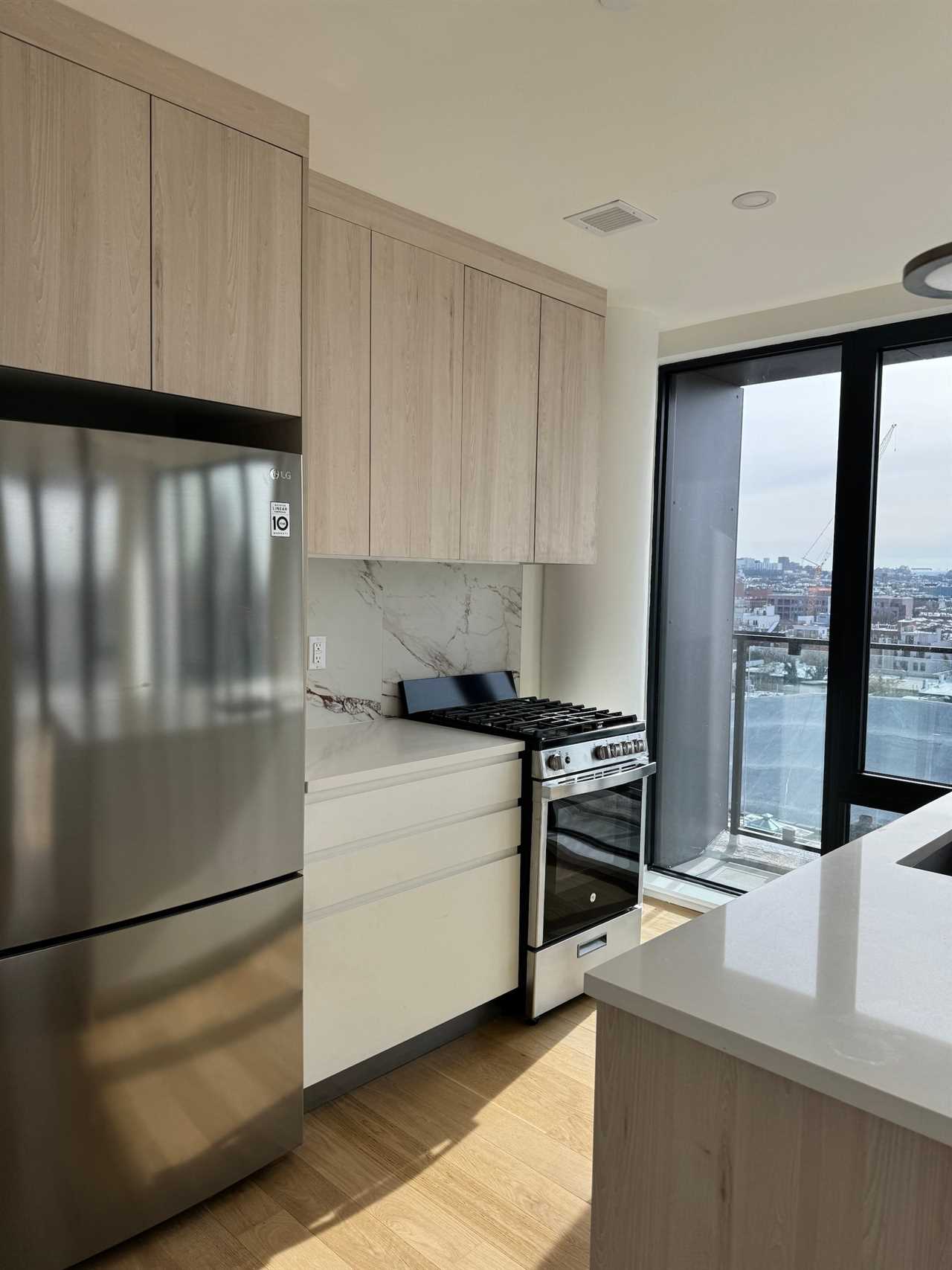 An empty kitchen with white counters.