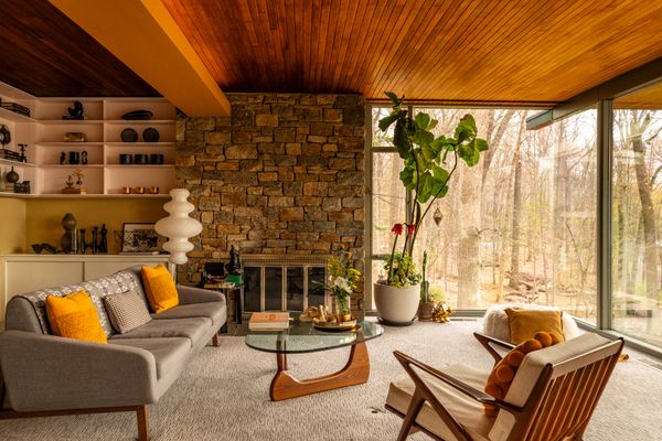 A stone fireplace sits below the tongue-and-groove California Cedar ceiling.