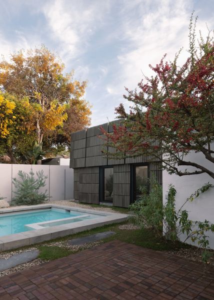 The ADU's materials are very craft-focused, from the custom terracotta tiles that are hand-cut in the factory, to the tinted green concrete base of the building.