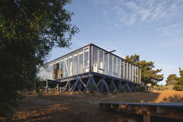 To avoid interfering too much with the sloping site, the architects raised the 2,000-square-foot home on low stilts placed in diagonal patterns. All of the timber was prefabricated to the architects’ specification by a specialized vendor and shipped ready for assembly.