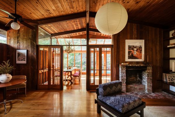 The house has been carefully preserved, with original wood finishes and a brick fireplace.