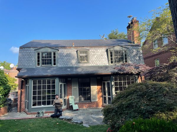The rear of the home featured two large bay windows and dormer windows on the upper floors. The lot was relatively long and narrow, with minimal side yards but a generous back yard.