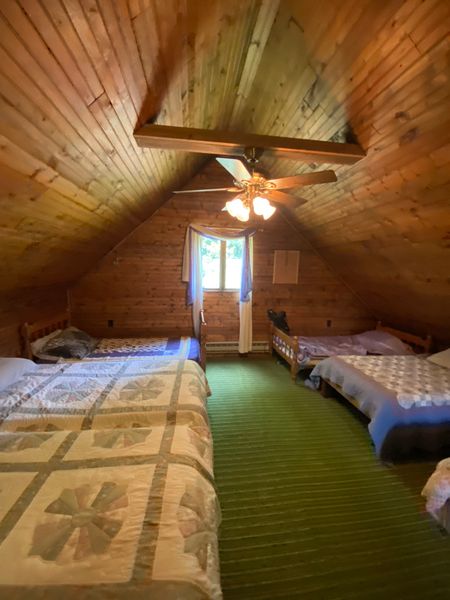 Before: The second floor landing had been arranged as a sort of dorm room, with several beds in the space under the pitched roof.