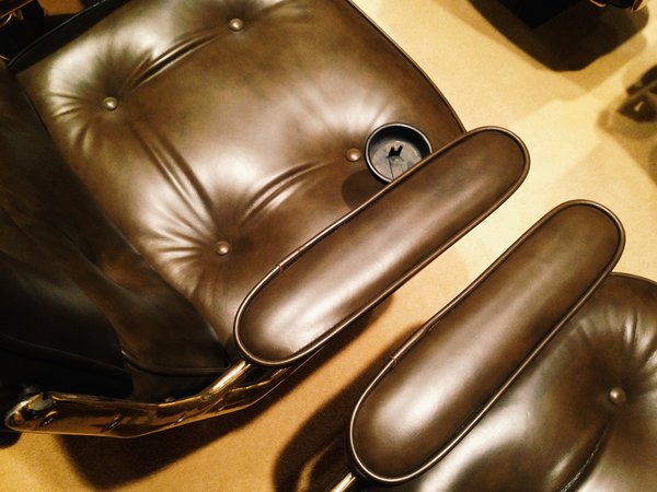 Charles and Ray Eames modified their executive chair with brown leather upholstery and brass accents (to match all that Platner flair). Note the intact pull-out ashtrays.