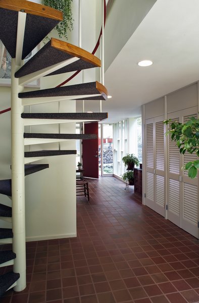 Looking beyond Hoover's circular staircase and closets to the new vestibule, with Heather Brown quarry tiles.