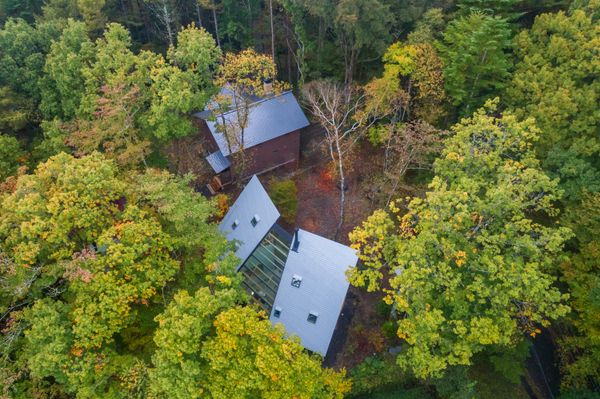 The weekend countryside retreat, known as a besso, has a steeply pitched rear facade that doubles as the roof.