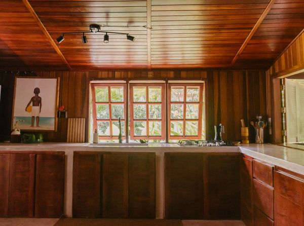 The couple also replaced the stove and extended the counters and cabinetry with an L-shaped layout. The windows provide views of the vegetation that surrounds the home. Jennifer says she spends a lot of time in the kitchen, even when she’s not cooking.