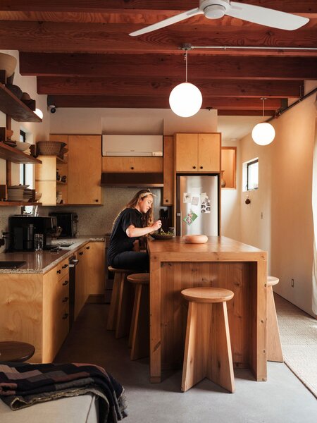 When Molly moved in, the kitchen already had cabinets, made of shamel ash from Angel City Lumber and topped with counters in terrazzo that Responsive Homes made using sediment from the Los Angeles River. She added an island to create 