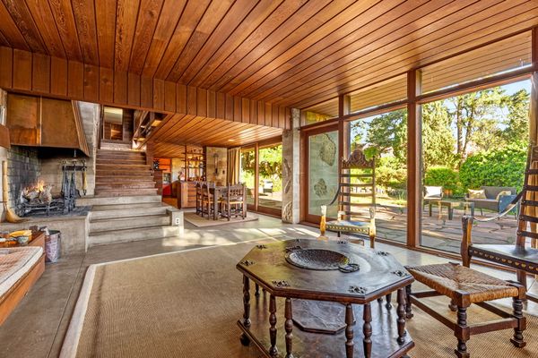 The wood-burning fireplace is vented with a copper hood.