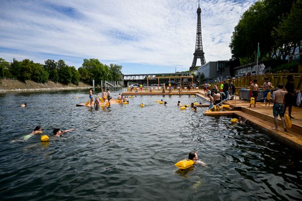 Swimmers in the water, at the Grenelle safe bathing site on the Seine river on its opening day, in front of the Eiffel Tower in Paris on July 5, 2025. The River Seine reopened to Parisian swimmers this morning for the first time since 1923, offering locals and tourists a welcome respite after scorching temperatures.
