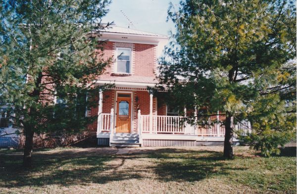 Before: By the 1990s, the home had acquired a front porch and two rear additions.