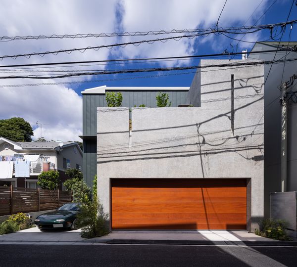 Half-Moon Cutouts Cast Dramatic Light Across This Concrete Home in Tokyo