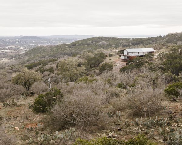 The house sits on a parcel of land near Lake Buchanan. An integrated rainwater collection system in the roof harvests 2,510 gallons per inch of rain—a nearby 29,175-gallon tank is the property's sole water source.