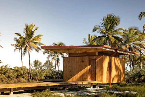 The sustainable structure sits slightly above ground and features beams and pillars made from glued laminated timber and wooden paneled walls constructed from cross laminated timber.