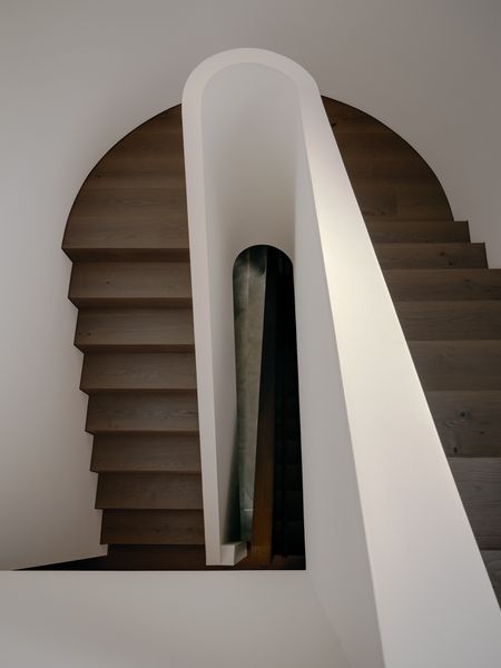 The staircase that sits at the heart of this renovation spans the levels in sinuous curves.