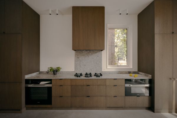 A palette of concrete, walnut, plaster, wood, and the architects’ favorite marble, Ceppo di Gre, imparts a timeless patina into the once-cramped interiors, as seen in the refreshed kitchen.