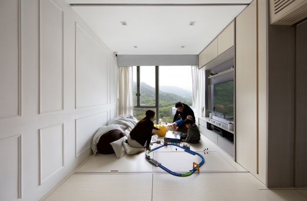Architect Patrick Lam outfitted a 484-square-foot apartment with operable floor panels that lift up to store luggage.