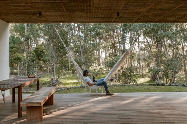 Ochoa relaxes on the deck’s hammock while drinking yerba maté, a beloved local herbal infusion typically sipped from a gourd. In the afternoon, the sun sets through the eucalyptus and pine trees that surround his half-acre property.