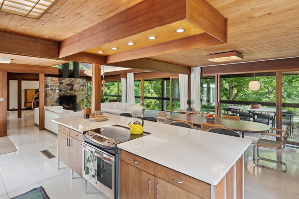 The kitchen's walnut cabinetry was designed by Paul McCobb.
