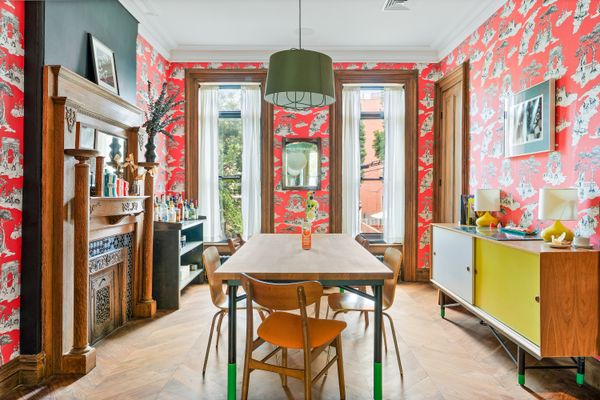 Vibrant pink wallpaper brightens up the dining room.