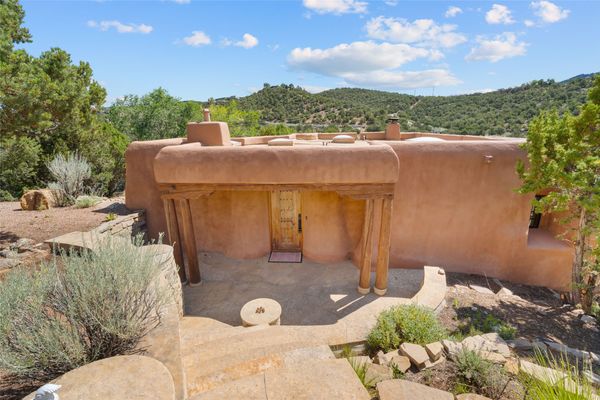 Set in the city’s historic Eastside neighborhood, this pueblo-style house has exposed beams, a kiva fireplace, and a curvaceous exterior.