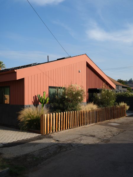 Knight combined Hardie board and wood siding on the exterior of the duplex, which consists of the ADU at left and a single-family unit at right—unifying them with Benjamin Moore's Burnt Sienna. The entrance to the ADU leads through a private patio that Hannah and Rami use year-round.