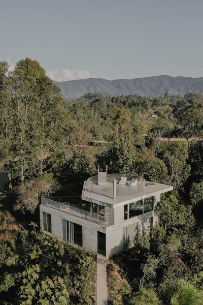 Stacked Geometric Shapes Form a Hillside Concrete Home in Colombia