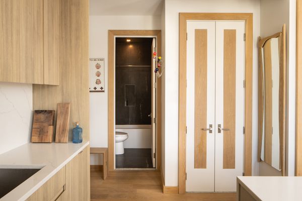 Shkurti kept the materials simple and soothing, so that the bathroom is a golden, moody surprise.