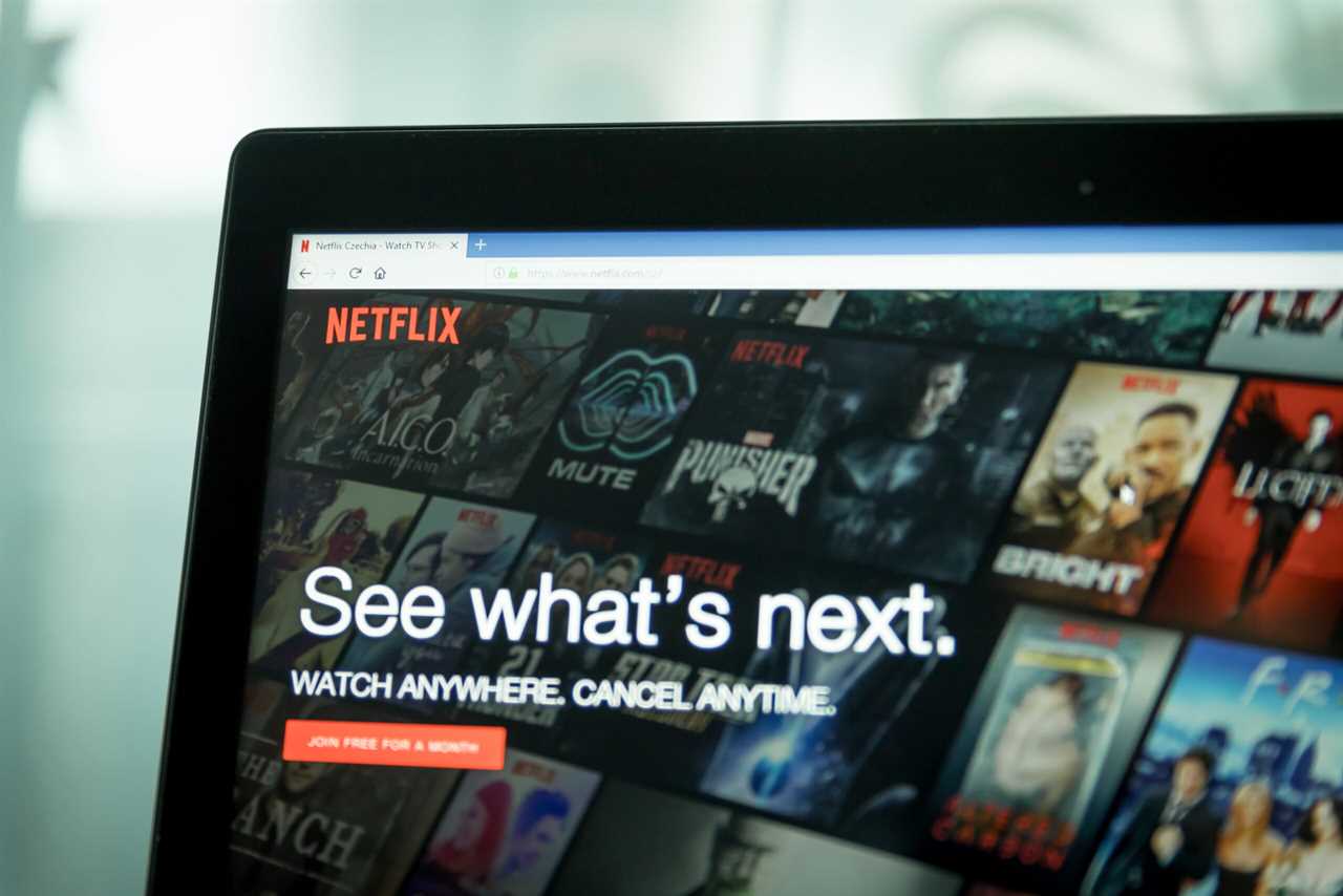 Netflix homepage displaying various shows and movies with a promotional message about watching anywhere and canceling anytime.