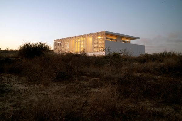 After purchasing a parcel of land in Todos Santos, Mexico, Greg Armas and Gabriela Minguez set out to design a 3-bed, 2-bathroom home. The resulting indoor/outdoor space is 1,900 square feet—with almost half of that occupied by open-air hallways and patios.