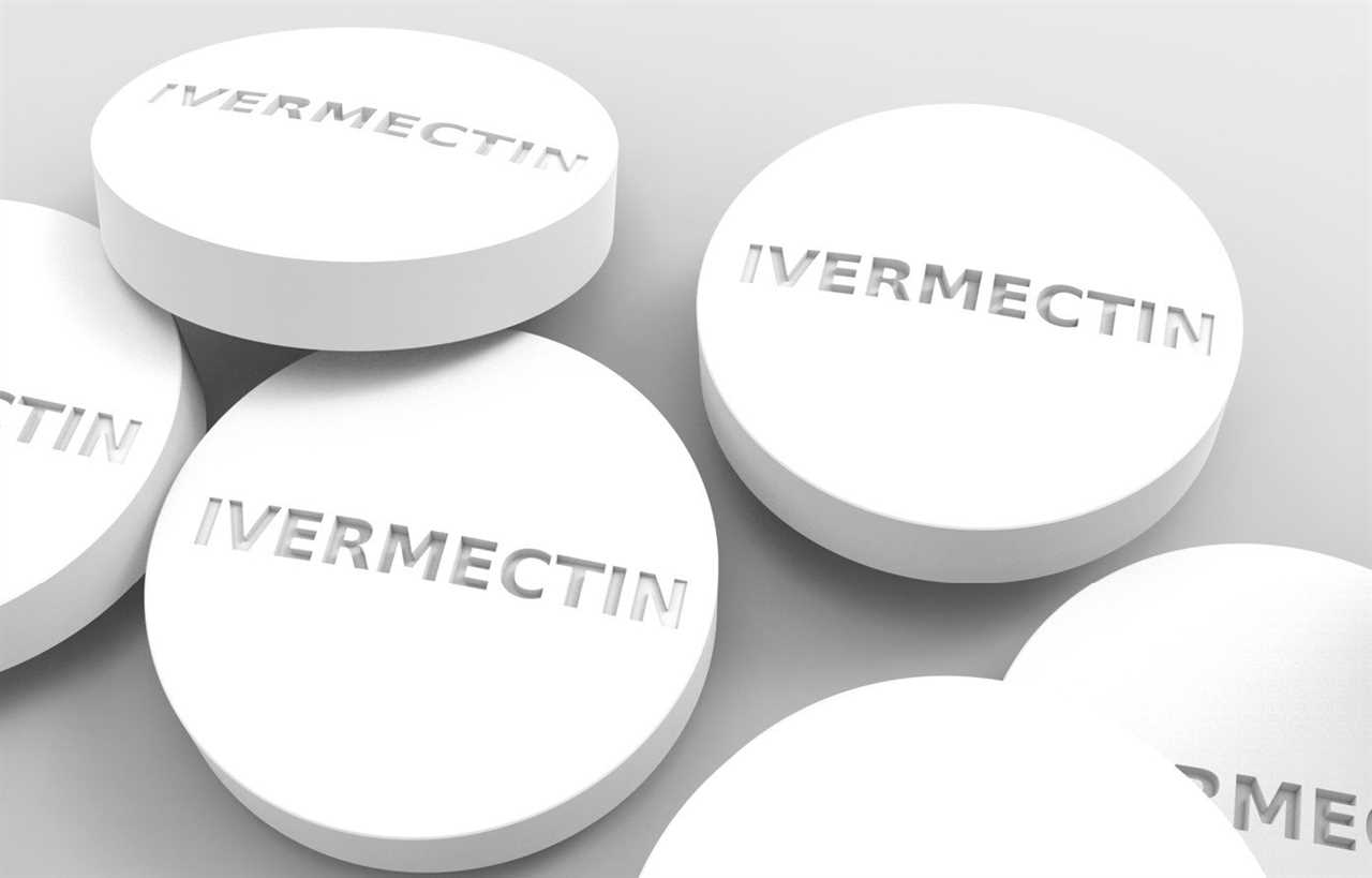 White Ivermectin tablets displayed on a neutral background, highlighting their round shape and embossed lettering.