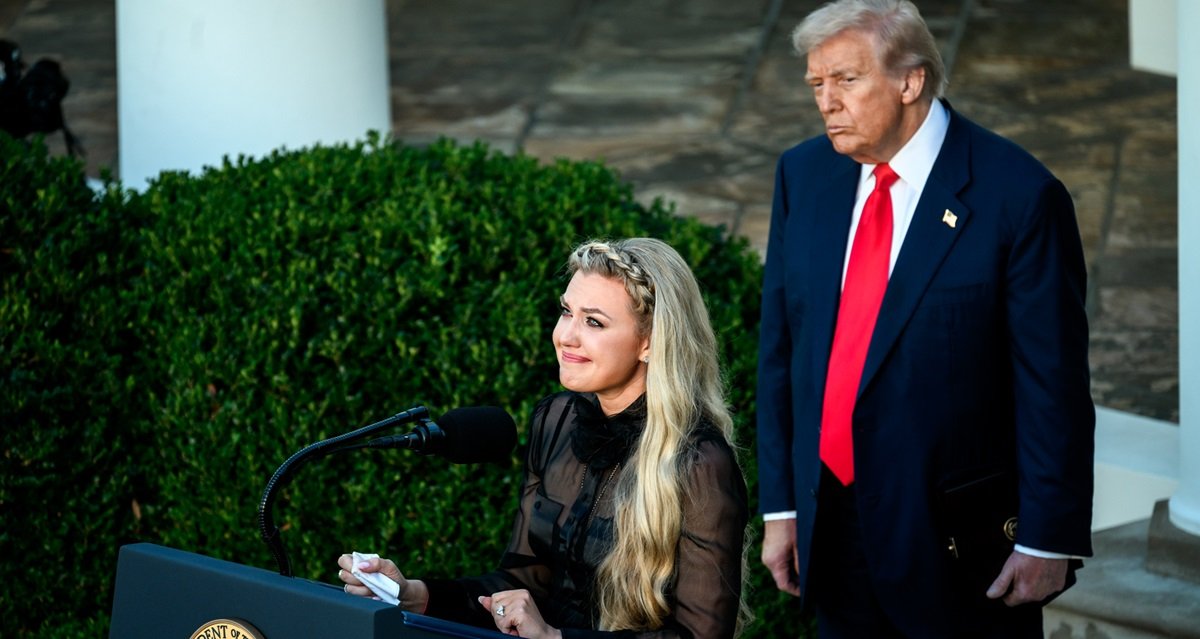 A woman speaks emotionally at a podium while Donald Trump stands behind her, both in the White House Rose Garden.