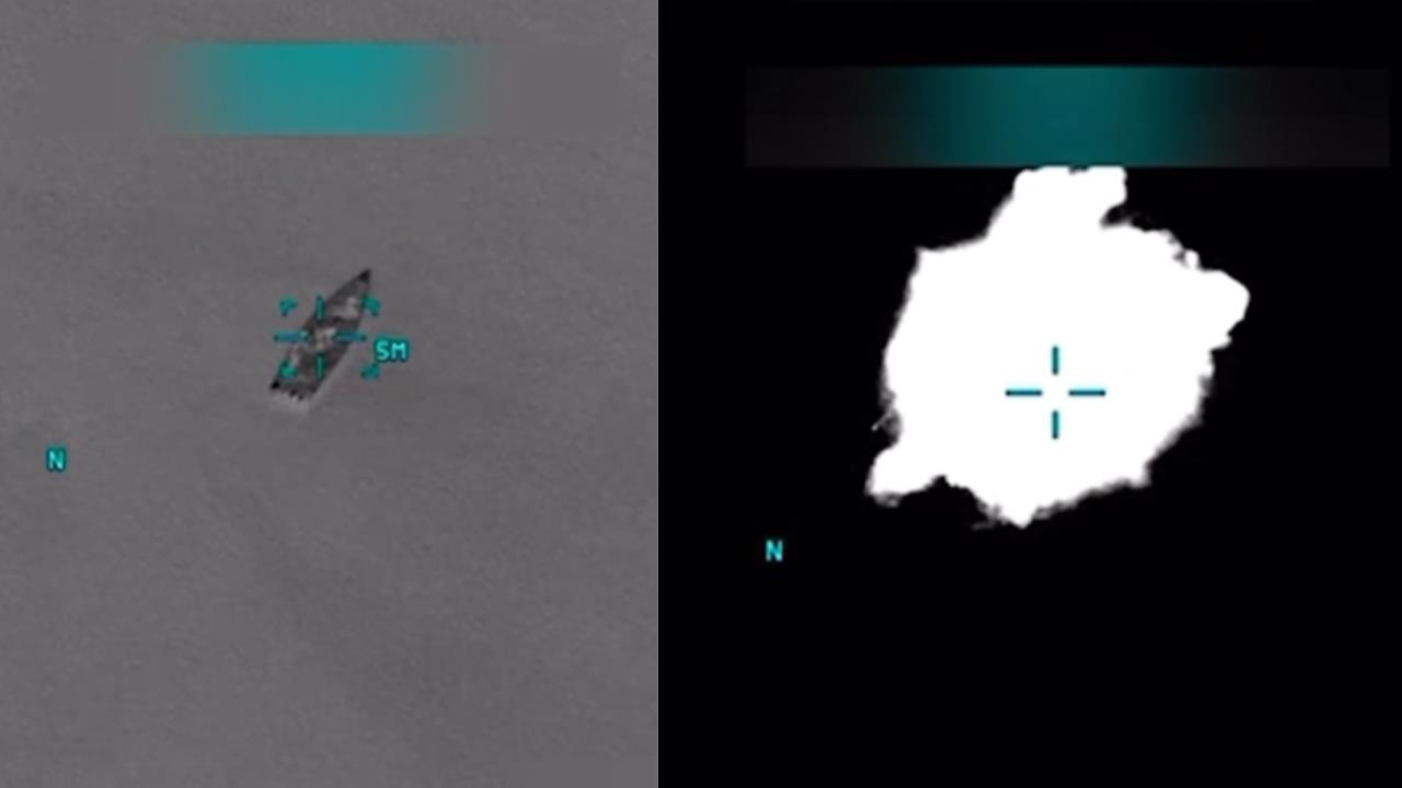 Thermal imaging showing a boat on water, highlighting navigation markers and environmental conditions for search and rescue operations.