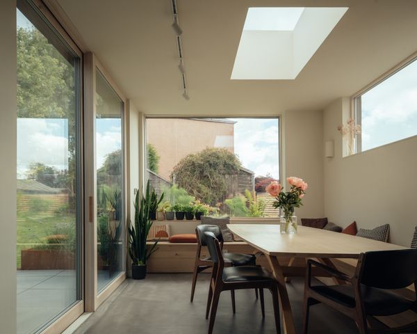 Sliding doors open out into the garden. The floors are microcement, a DIY project that took James one week to do.