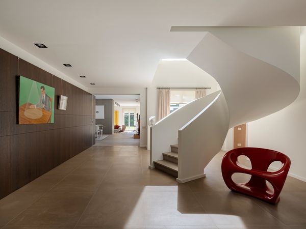 A Contemporary Villa in Belgium Comes Complete With a Landscape Pond and Showroom Garage