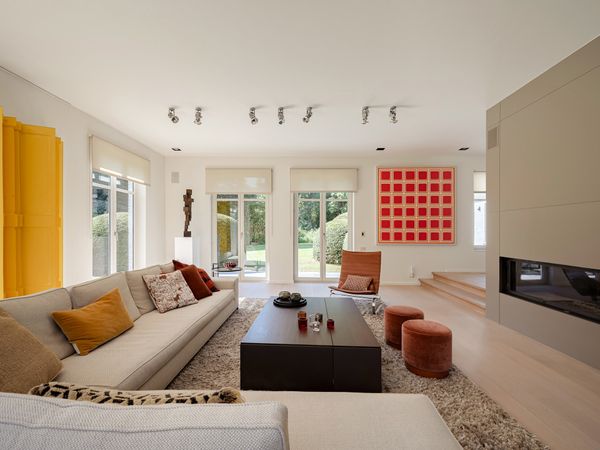A Contemporary Villa in Belgium Comes Complete With a Landscape Pond and Showroom Garage