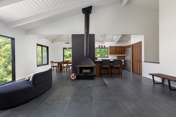 A vintage metal fireplace anchors the living room.