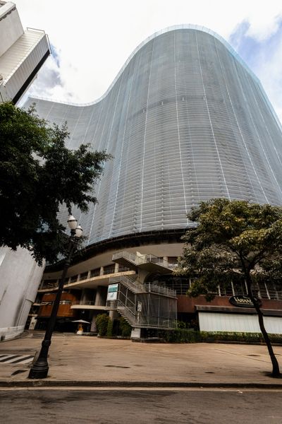 The Copan Building, designed by architect Oscar Niemeyer and completed in 1966, is a modernist icon in São Paulo, Brazil. The reinforced concrete construction made Niemeyer's signature curved facade feasible. It's so large, it has its own zip code, and there are more than 70 stores, restaurants, and commercial establishments on the lower level. "It's great to be here, you can get everything done on the ground floor of the building,
