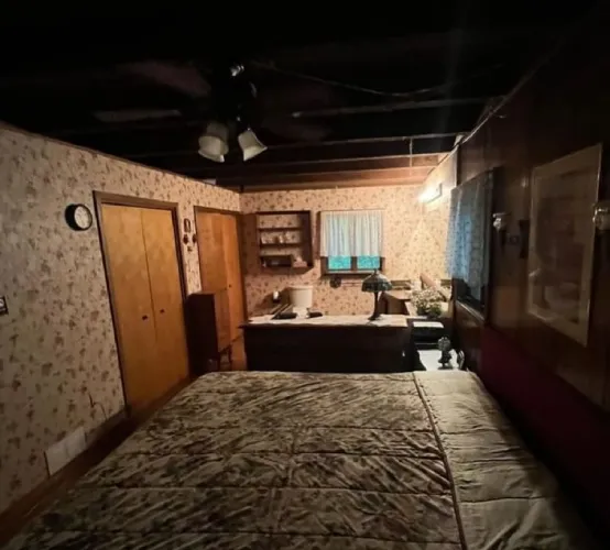 Dark bedroom with a small light at the back of the room