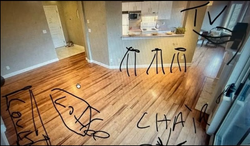 Living space overlooking a closed kitchen with proposed staging written in black marker on the photo.