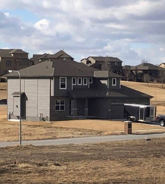 Two story house taken from afar at an angle.