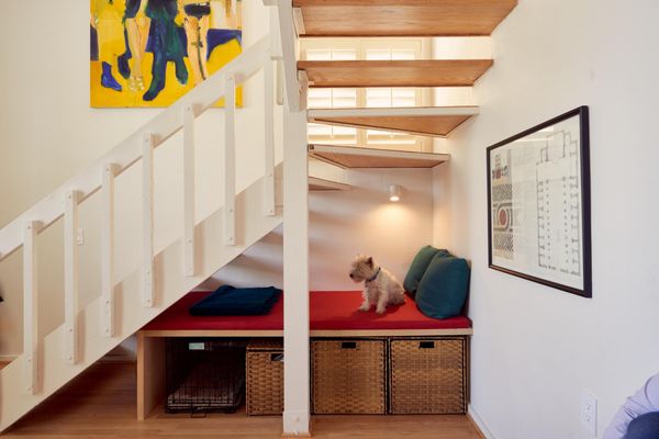 Space under the stairs is useful as storage (and an enticing spot for the couple's daughter and dog).