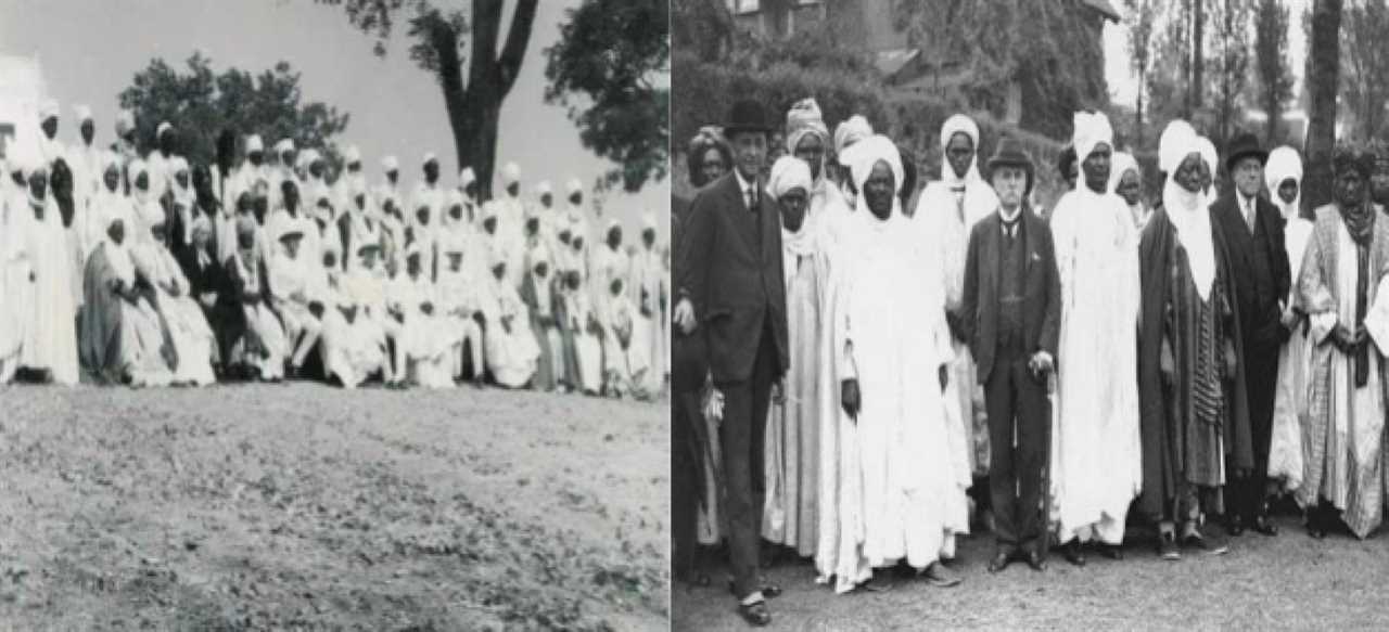 Historical black and white photograph featuring a group of individuals in traditional attire, showcasing cultural attire and diversity from a past era.
